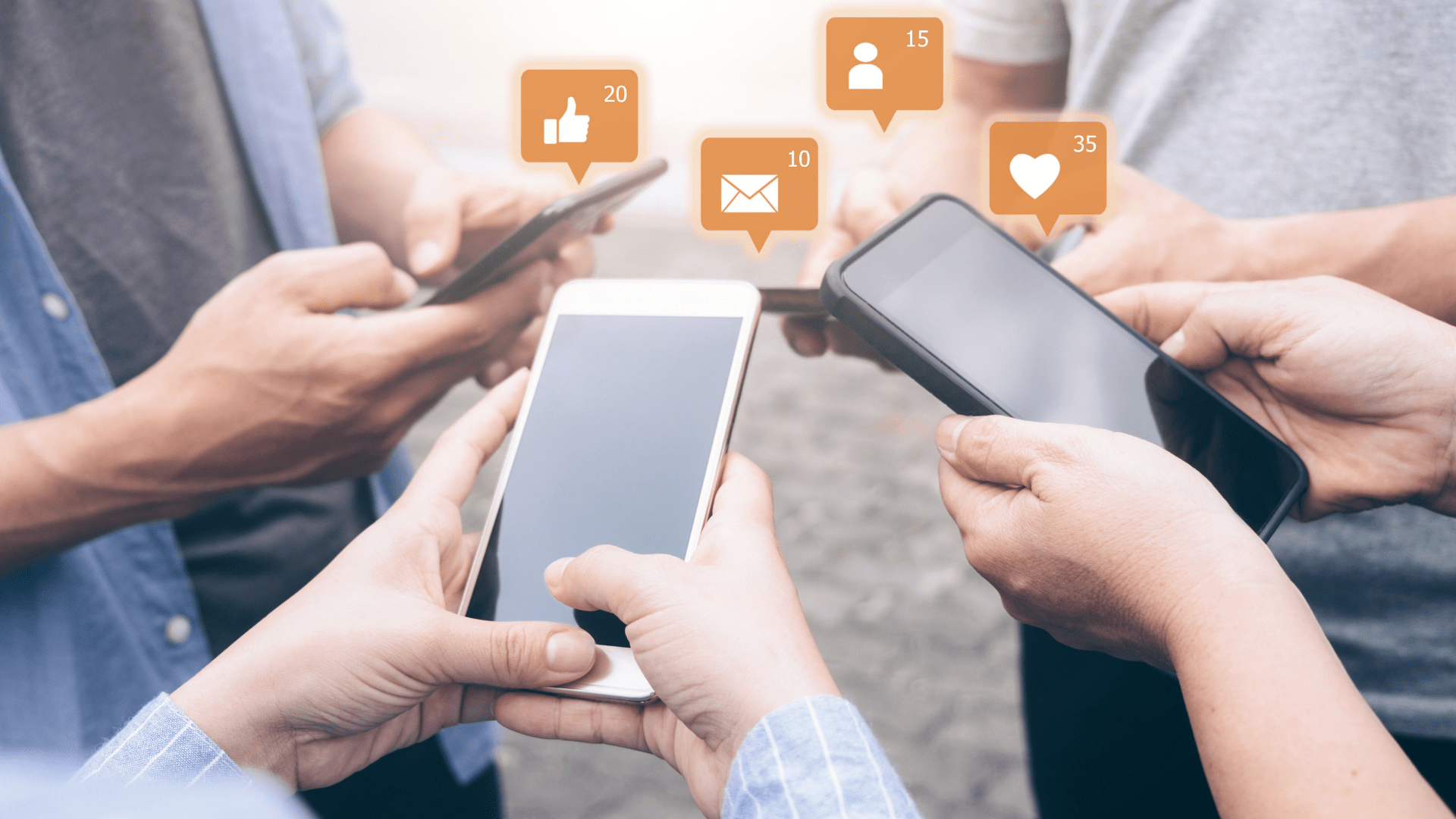 group of young people outside checking social in a circle